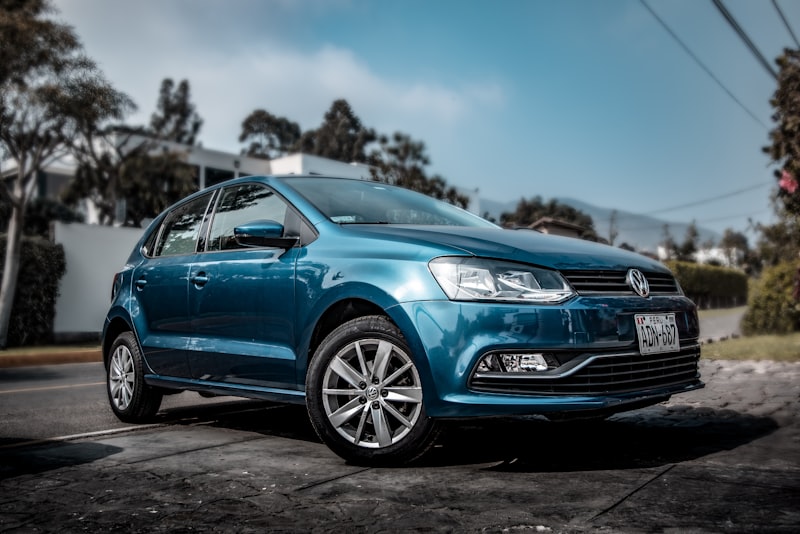 A used car parked on a quiet city street.